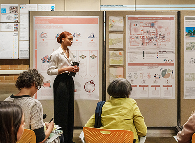 student at front of classroom leading discussion