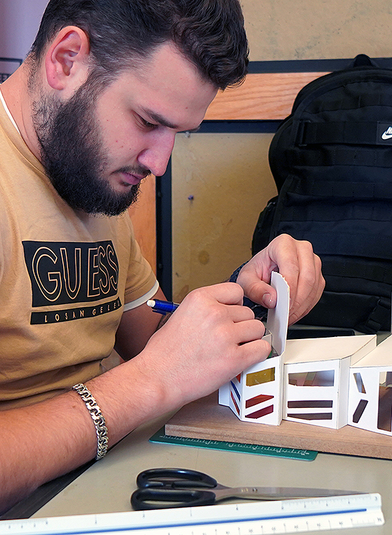 student looking at table of diaramas