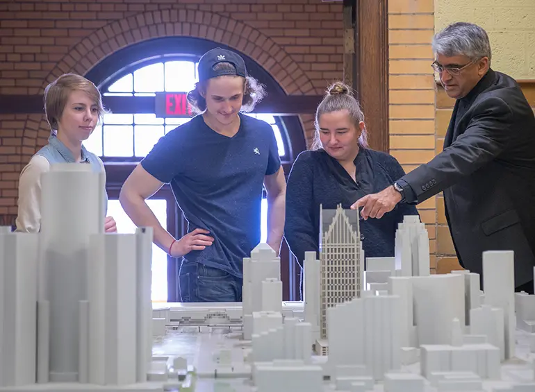 professor showing the students something about their models