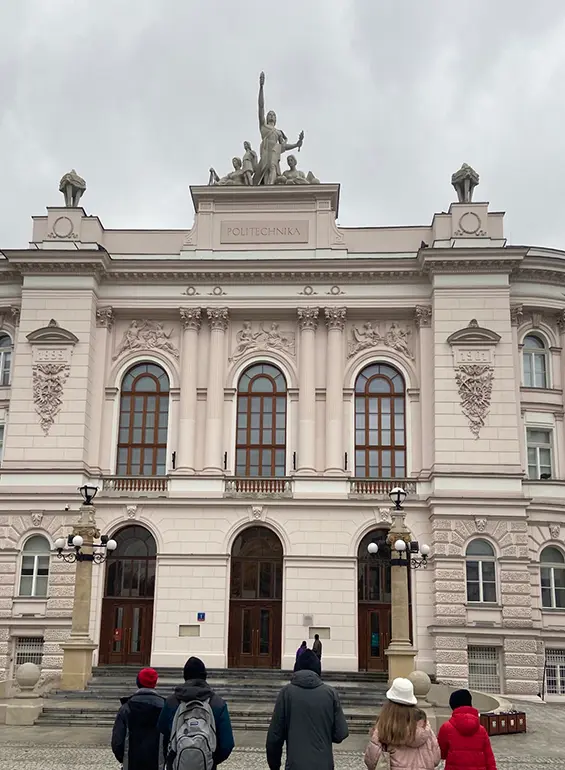 students in front of a building in Warsaw