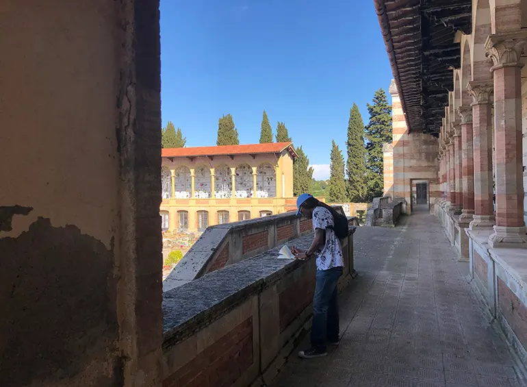 person on a balcony in volterra, italy